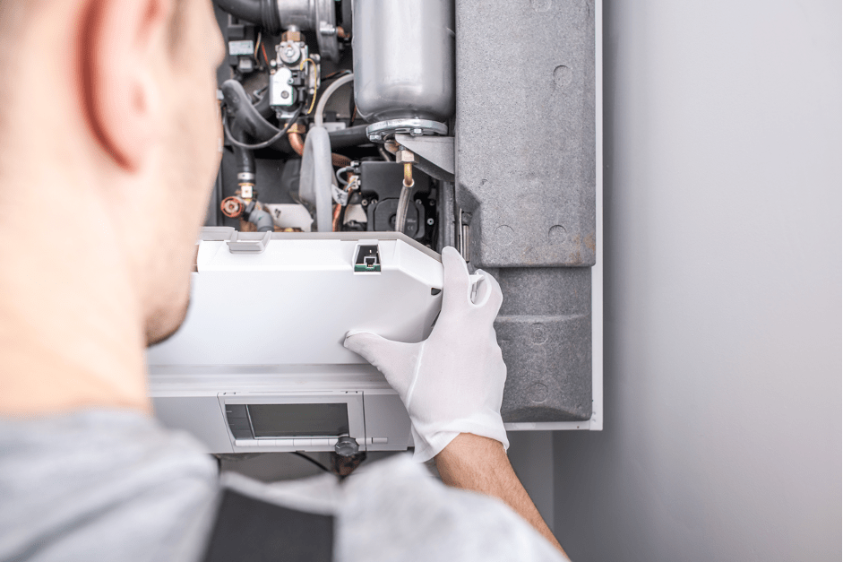 Heating technician repairing a leaking furnace at a house in Elgin, Illinois